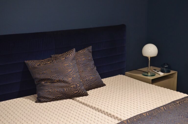 emma matras vs waterbed — Creative design of bedroom interior with bed and pillows with ornament near lamp on bedside table